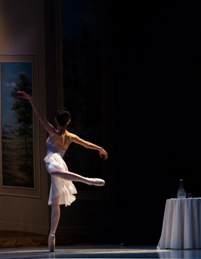 Ballet dancer on pointe in attitude taken on stage